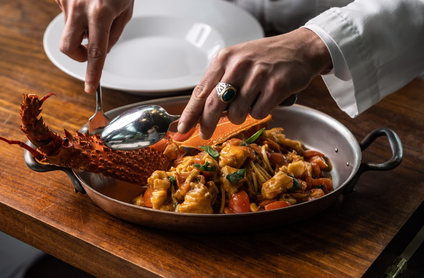 Chef plating up fresh fine dining seafood.